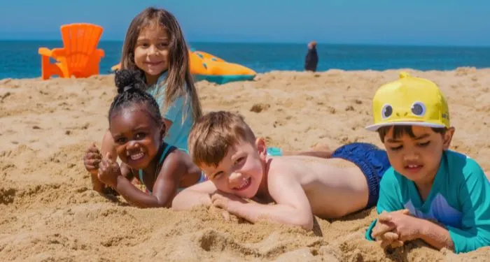 kids playing in sand at the beach